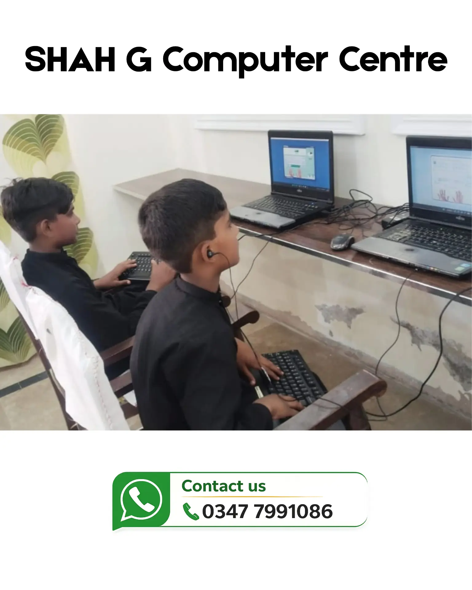 Two students practising on computers in the training classroom